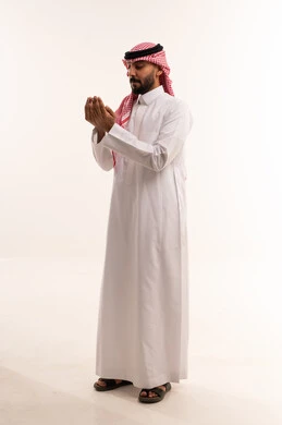 Saudi Man in Traditional Thobe Praying on White Background