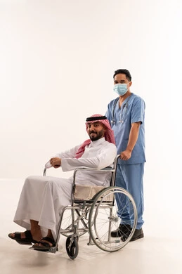 Saudi Man in Wheelchair with Asian Male Nurse