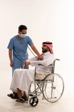 Saudi Man in Wheelchair Medical Checkup by Nurse