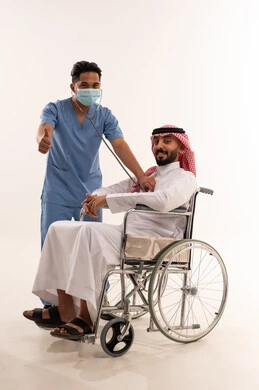 Saudi Patient in Wheelchair with Nurse Medical Exam