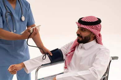 Saudi Patient in Wheelchair Having Blood Pressure Measured