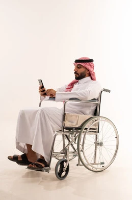 Saudi Man in Wheelchair Using Smartphone