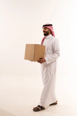 Saudi Man in Traditional Dress Carrying Shipping Box