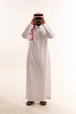 Saudi Man in Traditional Thobe Using Binoculars