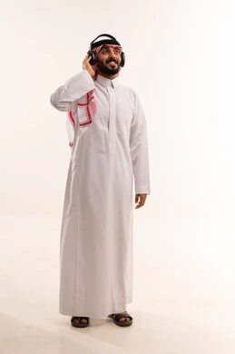 Saudi Man Wearing Headphones in Traditional Thobe