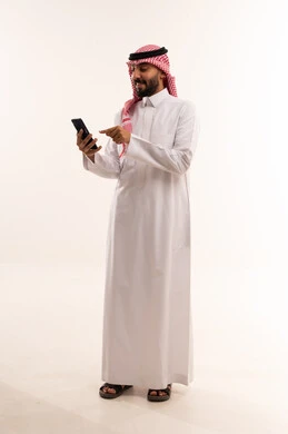 Saudi Man in Traditional Thobe Using Smartphone