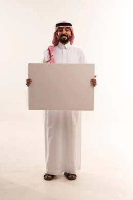 Saudi Man in Traditional Thobe Holding Blank Sign