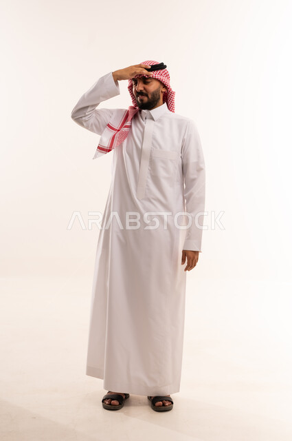 Saudi Man in Traditional Thobe Looking Away