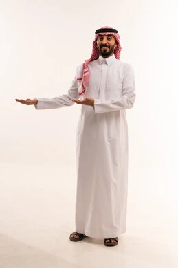 رجل سعودي بالزي التقليدي يشير على خلفية بيضاء