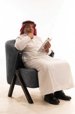Senior Saudi Man Writing on Clipboard White Background