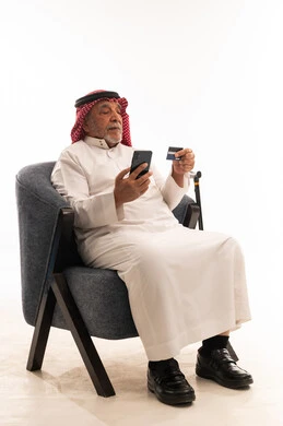 Elderly Saudi Man Online Shopping with Credit Card
