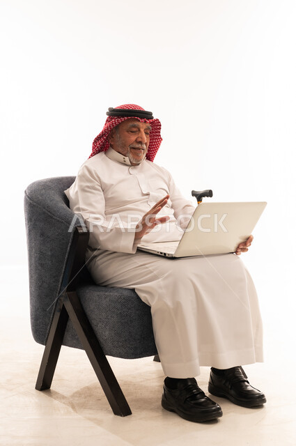 Elderly Saudi Man Using Laptop in Studio