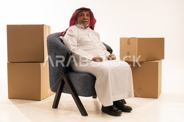 Elderly Saudi Man with Moving Boxes in Studio