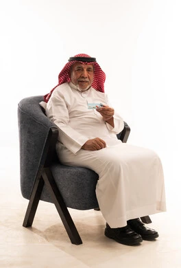 Elderly Saudi Man Holding Identity Card in Studio