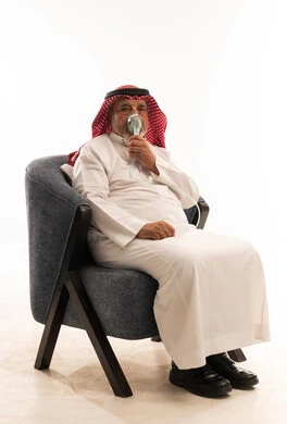 Elderly Saudi Man Using Nebulizer Treatment