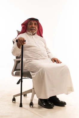 Elderly Saudi Man in Traditional Dress with Cane