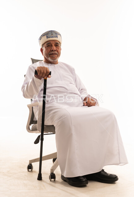 Senior Omani Man in Traditional Dress with Cane