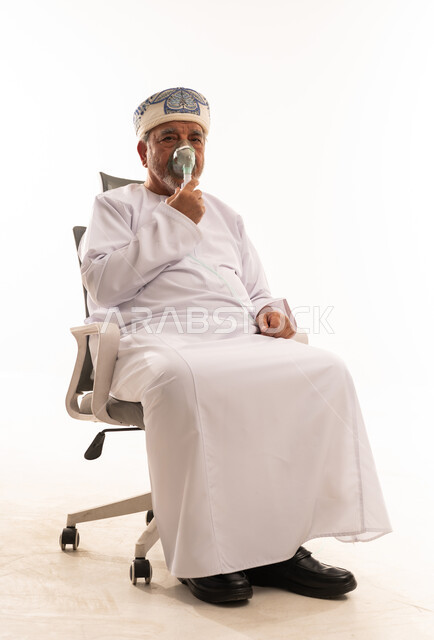 Omani Senior Man Using Oxygen Mask in Studio