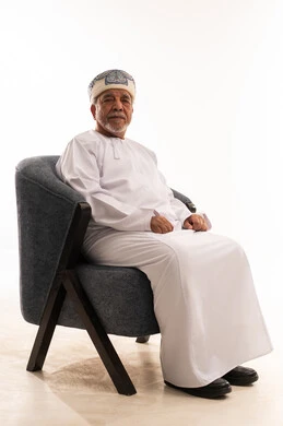 Elderly Omani Man in Traditional Dress on White Background