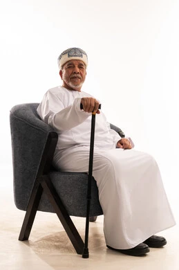 Elderly Omani Man in Traditional Dress with Cane