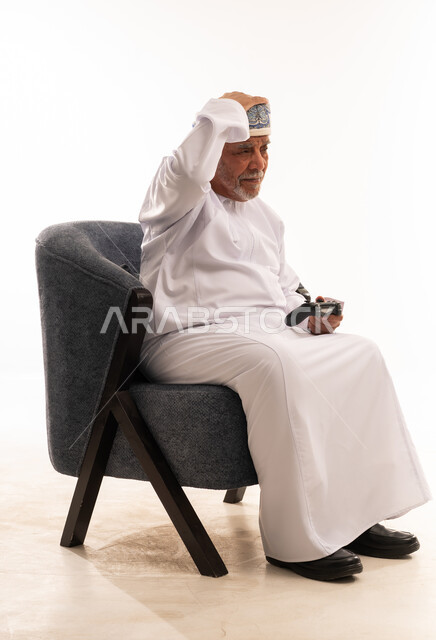 Elderly Omani Man with Video Game Controller