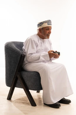 Omani Senior Man Playing Video Games in Studio