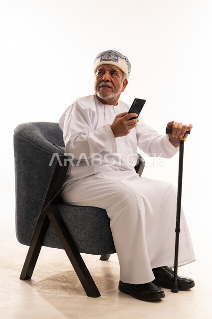 Elderly Omani Man with Smartphone in Studio