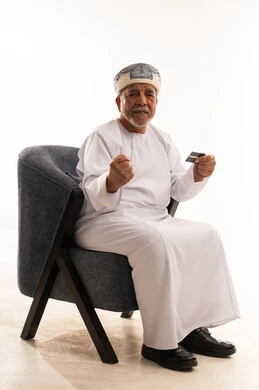 Elderly Omani Man with Credit Card on White Background