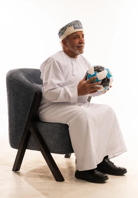 Omani Senior Man in Traditional Dress Holding Soccer Ball