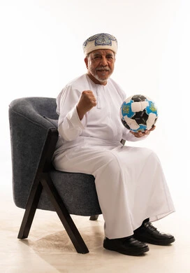 Elderly Omani Man Celebrating with Soccer Ball