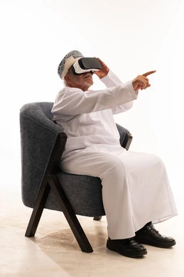 Elderly Omani Man Using VR Headset on White Background