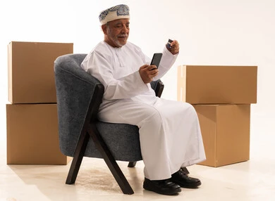 Omani Senior Man Shopping Online with Credit Card