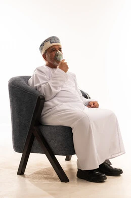 Omani Elderly Man Using Nebulizer Mask in Studio