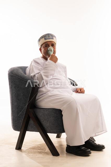 Elderly Omani Man Using Oxygen Mask in Studio