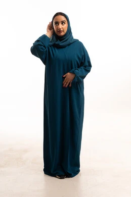 Saudi Woman in Teal Abaya Listening in Studio