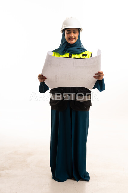 Saudi Female Engineer with Blueprint and Hard Hat