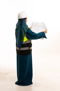 Arab Female Engineer in Abaya Reviewing Blueprints