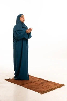Saudi Woman Praying in Teal Abaya on White Background
