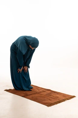 Saudi Woman Performing Ruku Prayer on White Background