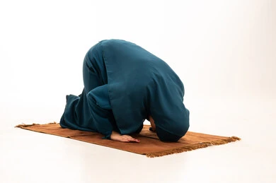 Muslim Woman in Prostration on Prayer Rug