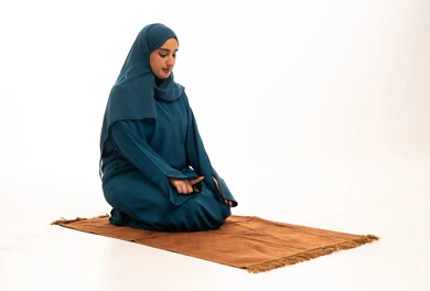Muslim Saudi Woman Praying on Rug White Background