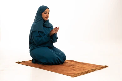 Saudi Woman in Blue Hijab Praying on White Background