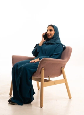 Saudi Woman in Abaya Calling on Smartphone in Studio