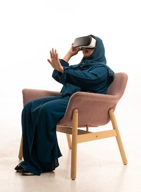 Saudi Woman Using VR Headset in Teal Abaya