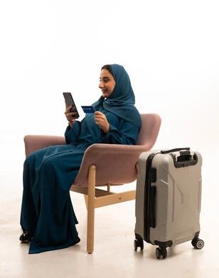 Saudi Woman with Suitcase Booking Trip Online