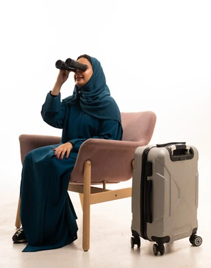 Saudi Woman with Binoculars and Travel Suitcase