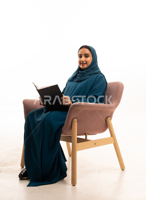 Saudi Woman Reading Book in Teal Abaya