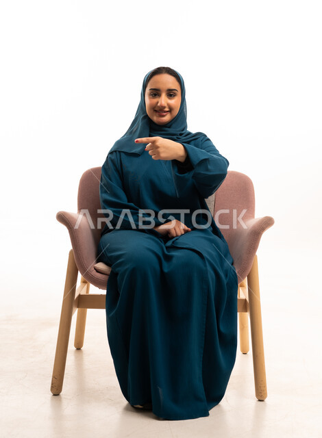 Saudi Woman in Teal Abaya Pointing at Camera