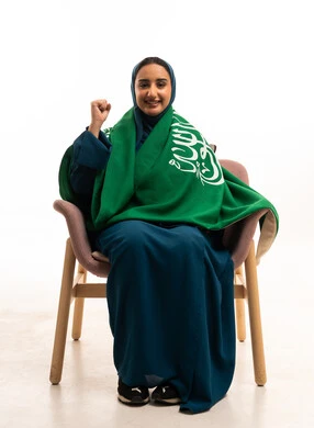 Saudi Woman with National Flag Celebrating Success
