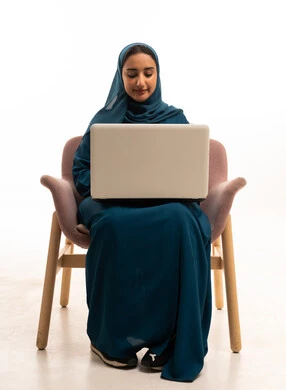 Emirati Woman Working on Laptop in Abaya